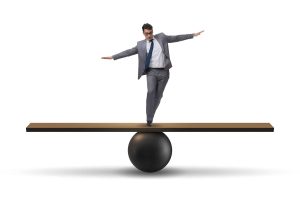 Manager on a seesaw trying to balance autonomy