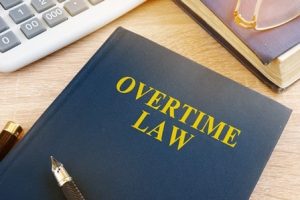 Overtime law written on an office notebook