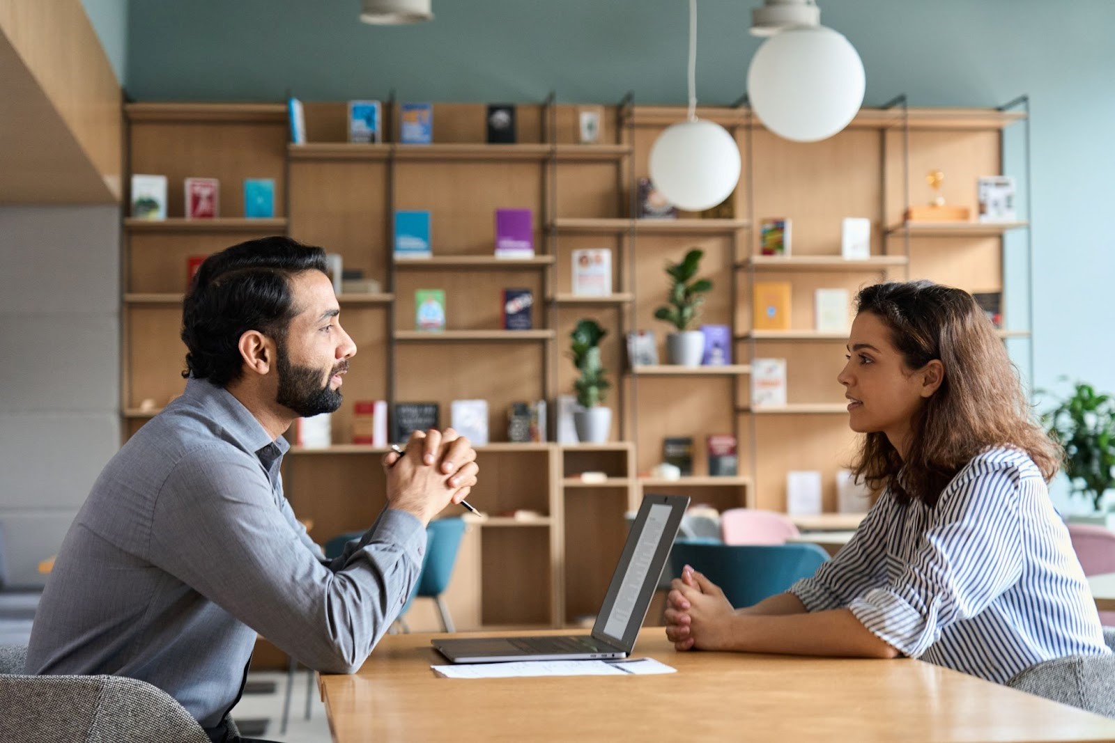 Photo of man sitting across from woman